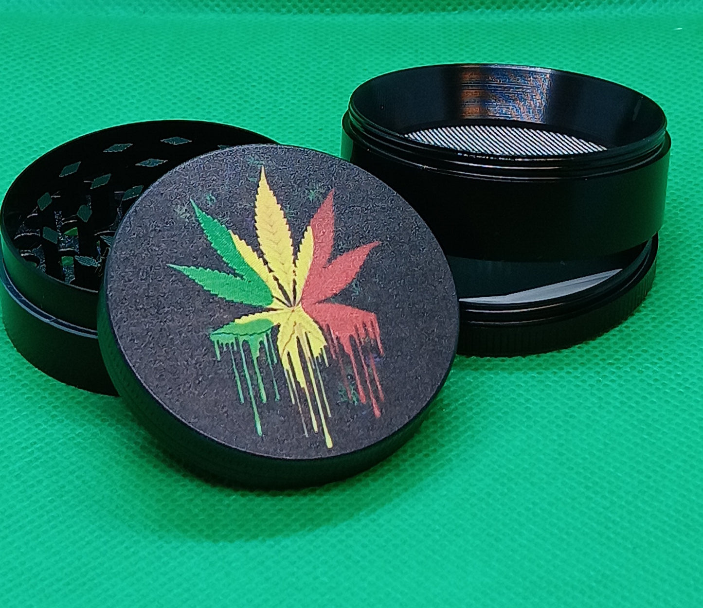 4 pc dripping rasta pot leaf grinder 2"