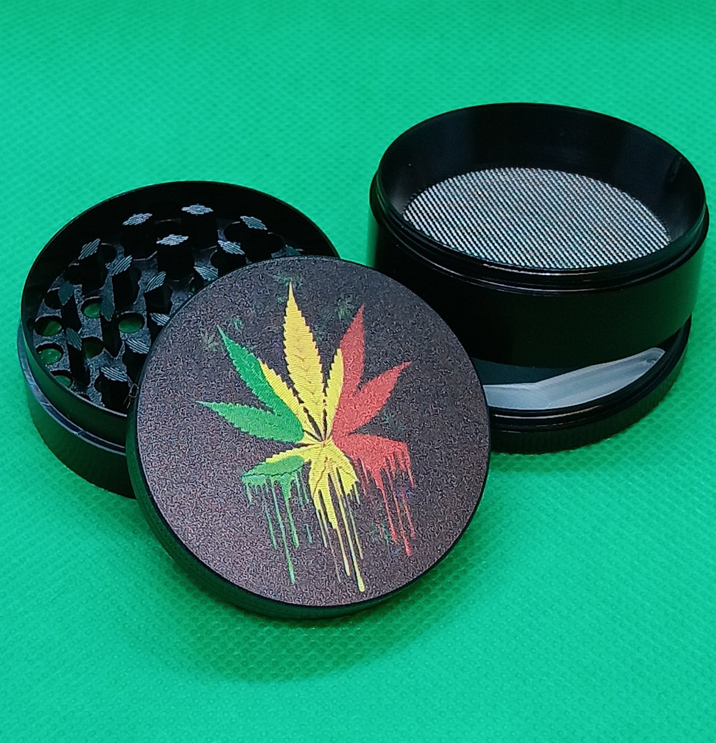 4 pc dripping rasta pot leaf grinder 2"